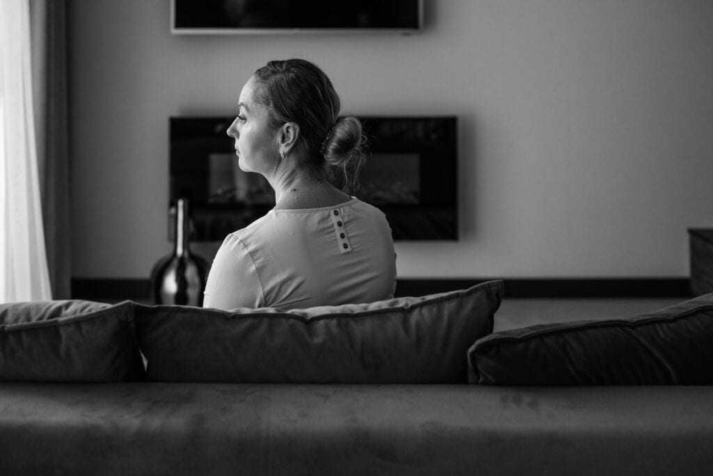 black and white back of woman's head sad